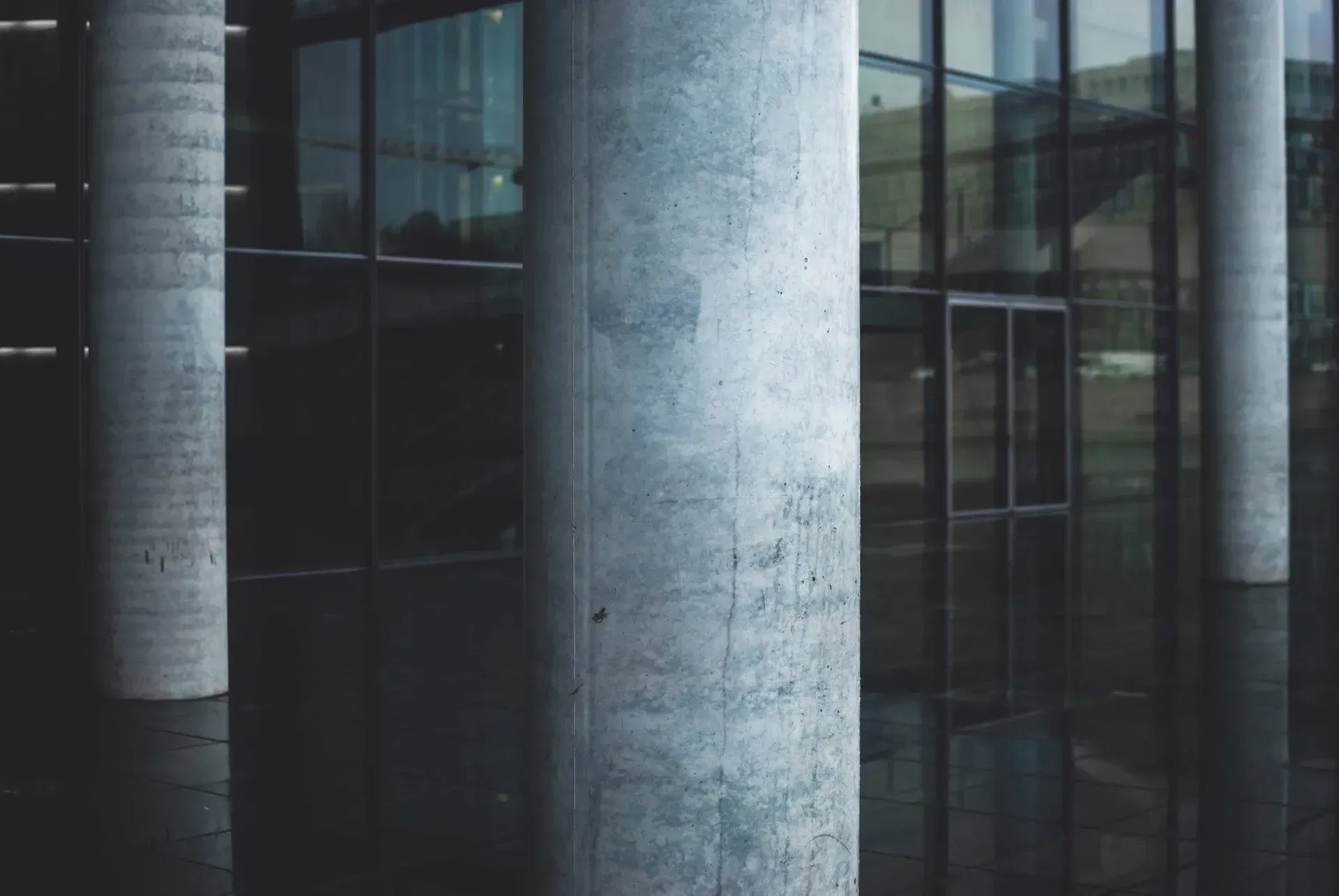 A Building with A Lot of Windows and Columns in Front of It — Concrete Colour Solutions in Heatherbrae, NSW
