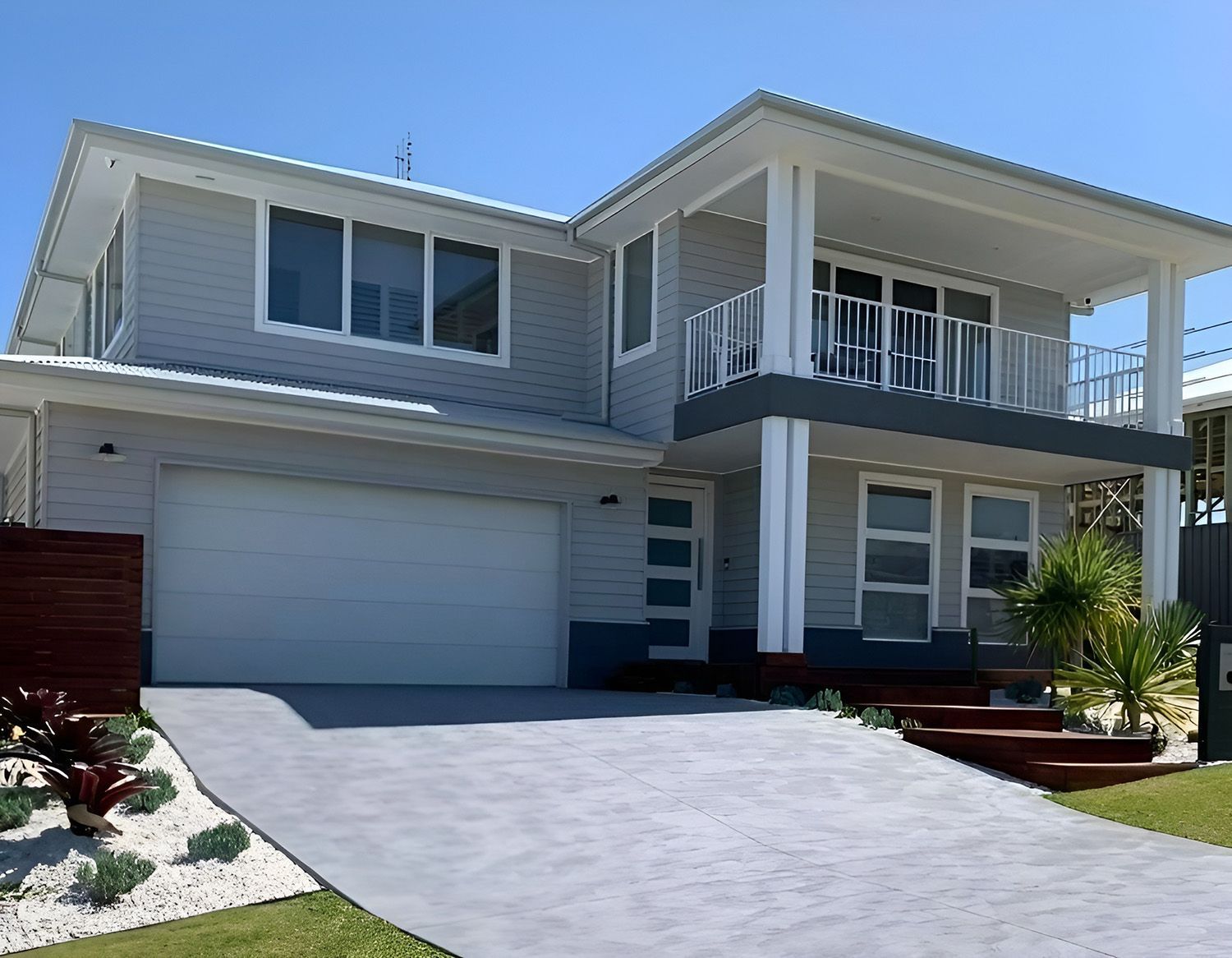 Two-story Modern Gray House With White Trim, Garage, and a Sloped Driveway — Concrete Colour Solutions in Muswellbrook, NSW