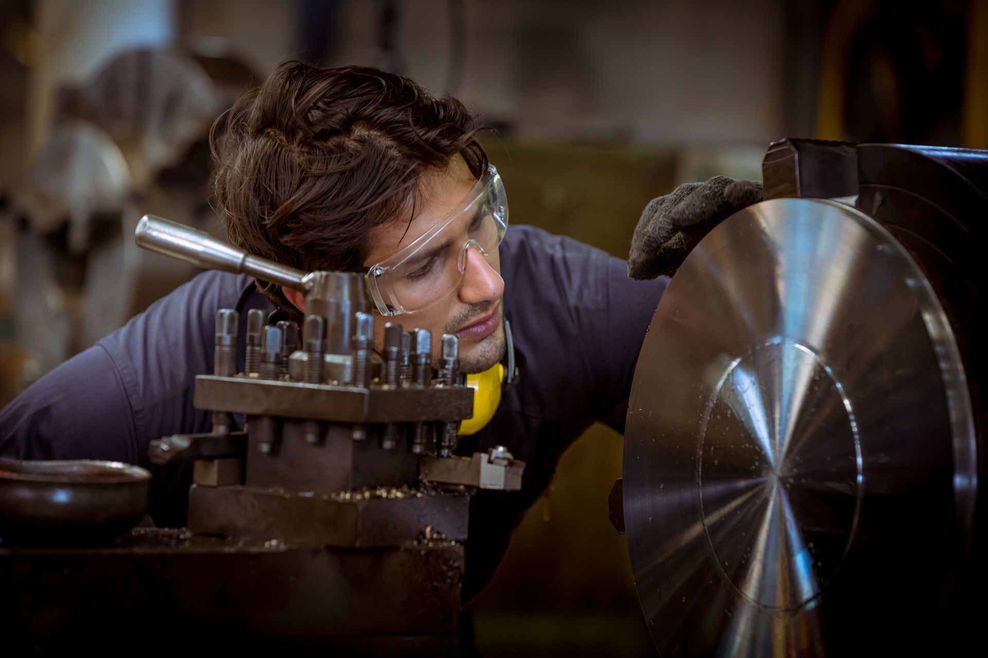 A man is working on a machine in a factory.