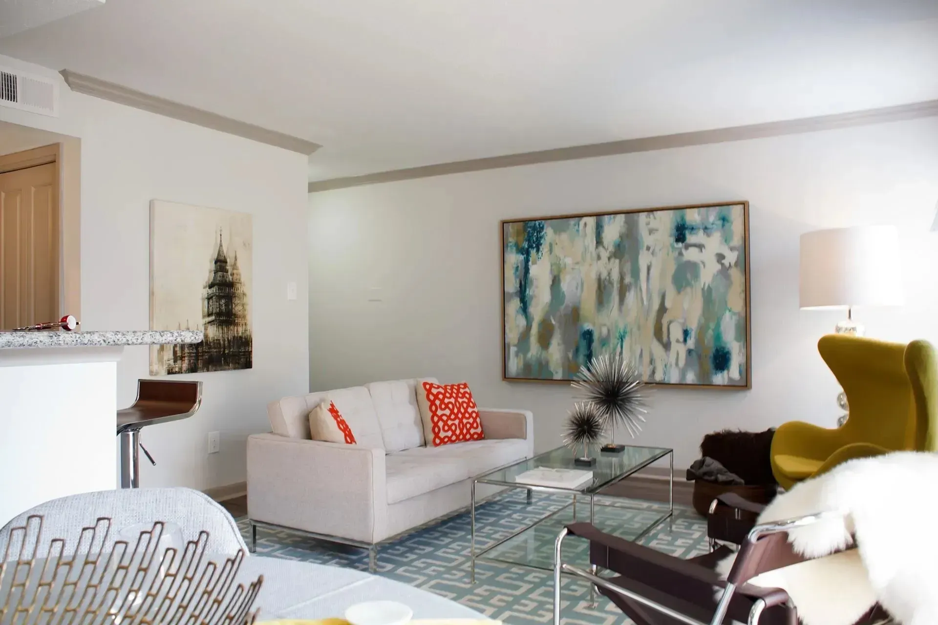Living room with sofa, artwork, accent chair, and coffee table.