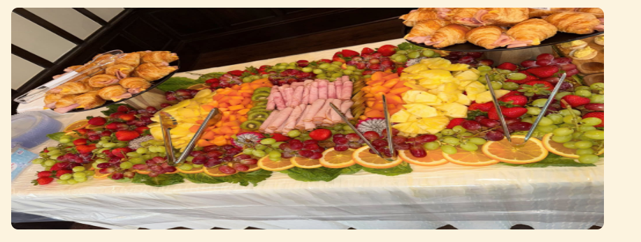 Colorful market display of assorted pastries, fruit, and desserts arranged on a table