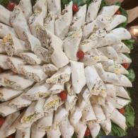White flower garland with red accents arranged in a circular pattern
