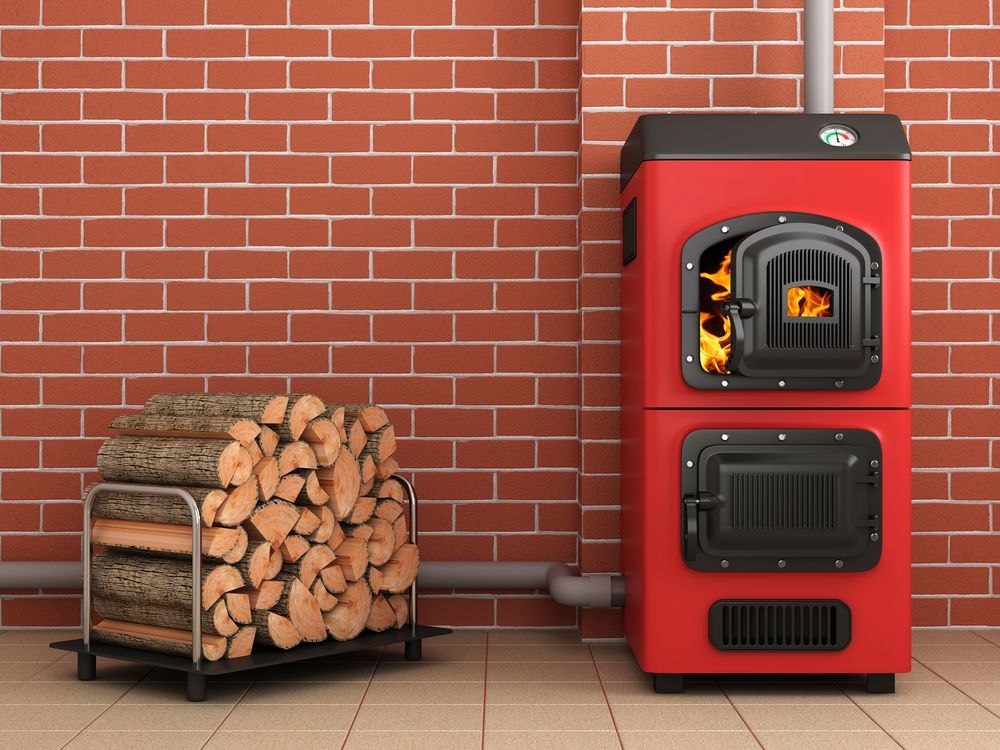 A Bright Red Wood-burning Boiler Sits on a Tiled Floor — The Flue Pro In Huntingfield, TAS