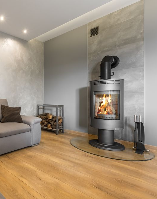 Modern Living Room With a Lit Wood-burning Stove on a Glass Hearth — The Flue Pro In Huntingfield, TAS