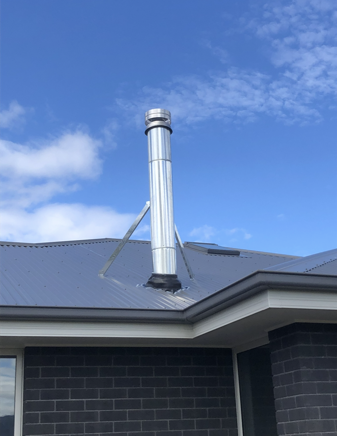Metal Chimney Vent on a Grey Rooftop — The Flue Pro In Burnie, TAS
