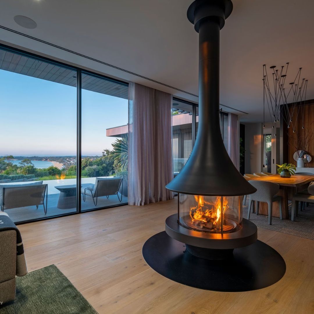 A Modern Living Room Features a Circular Hanging Fireplace — The Flue Pro In Huntingfield, TAS