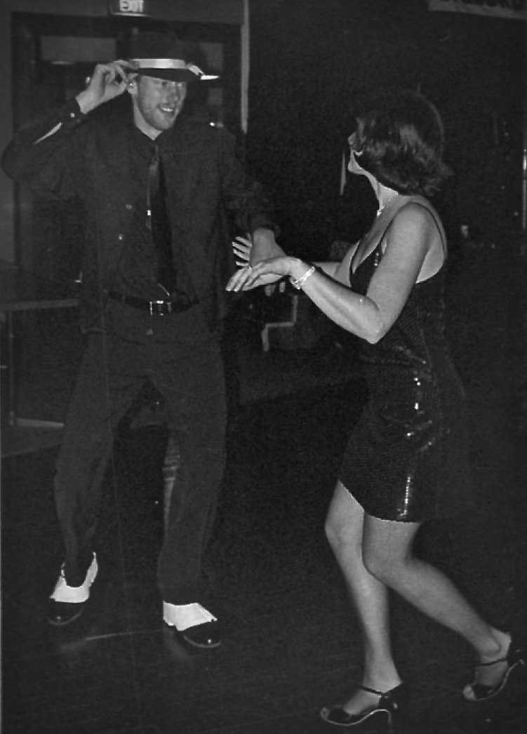 A black and white photo of a man and woman dancing