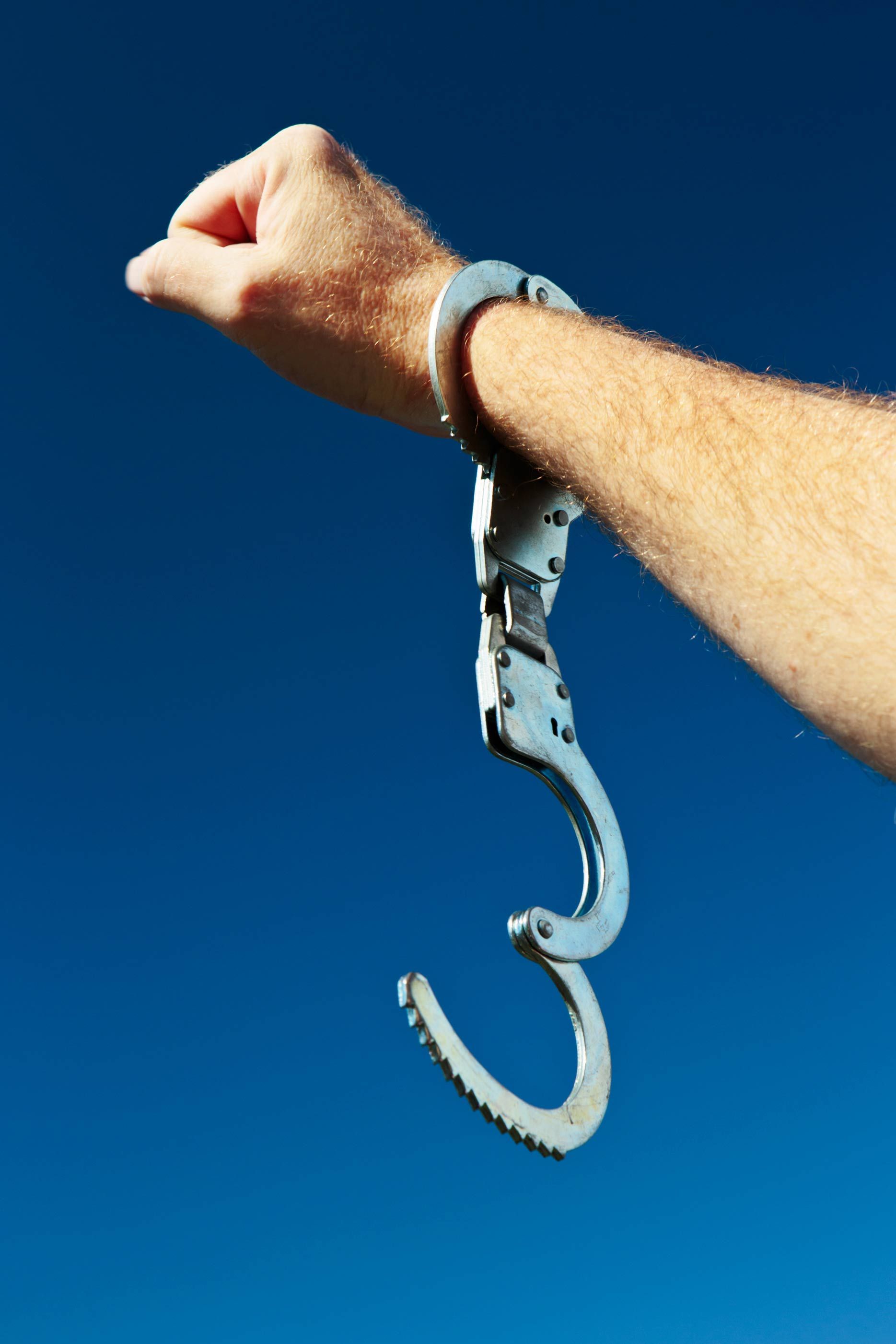 Free At Last! Hand With Clenched Fist And Open Handcuff — Vero Beach, FL — Barnett Bail Bonds Free At Last! Hand With Clenched Fist And Open Handcuff — Vero Beach, FL — Barnett Bail Bonds