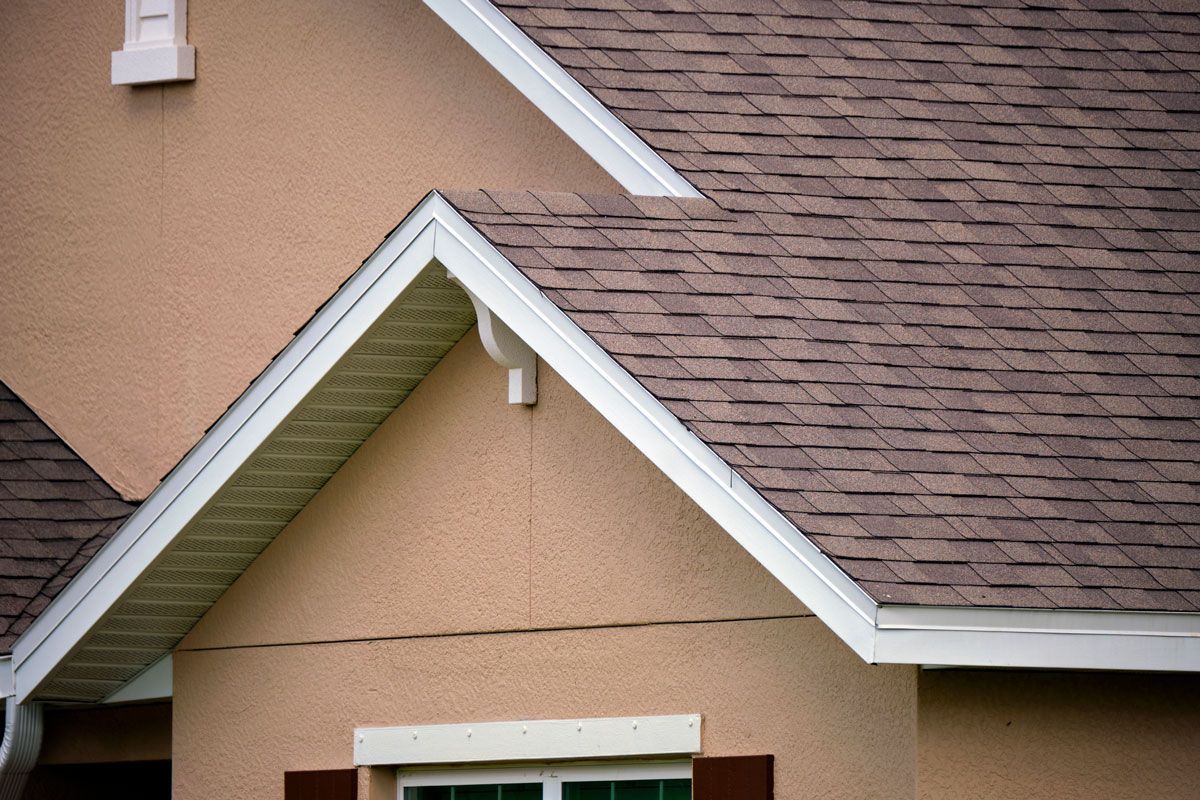 A house with a brown roof and white trim