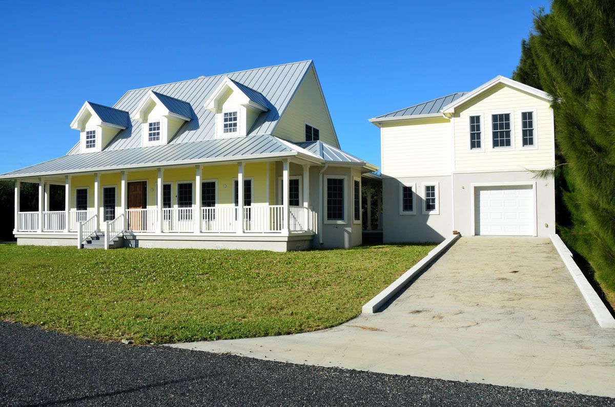 A house with a brown roof and white trim