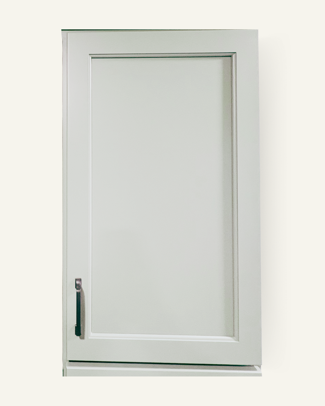 White kitchen cabinet with a single door and chrome handle.