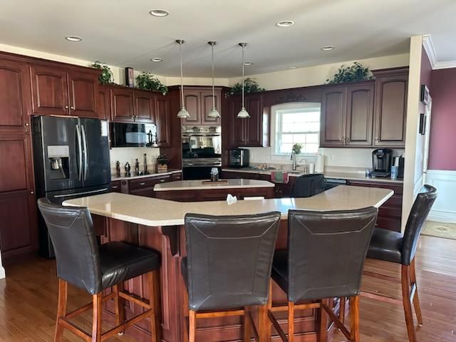 Before: dark wood cabinets; After: light, painted kitchen cabinets