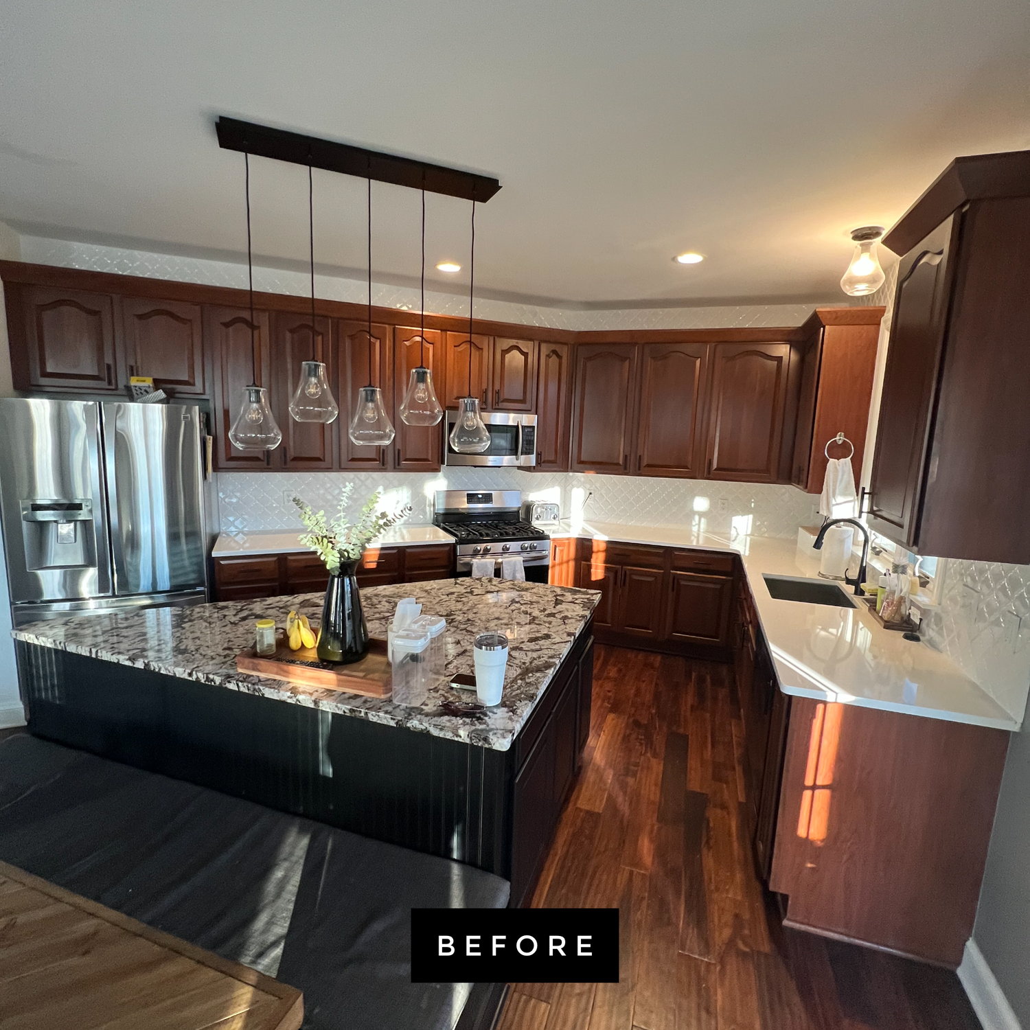 Kitchen with dark wood cabinets, granite countertops, and stainless steel appliances.