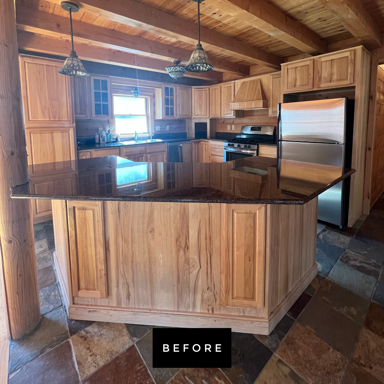 Wooden kitchen with granite countertops and stainless steel appliances.
