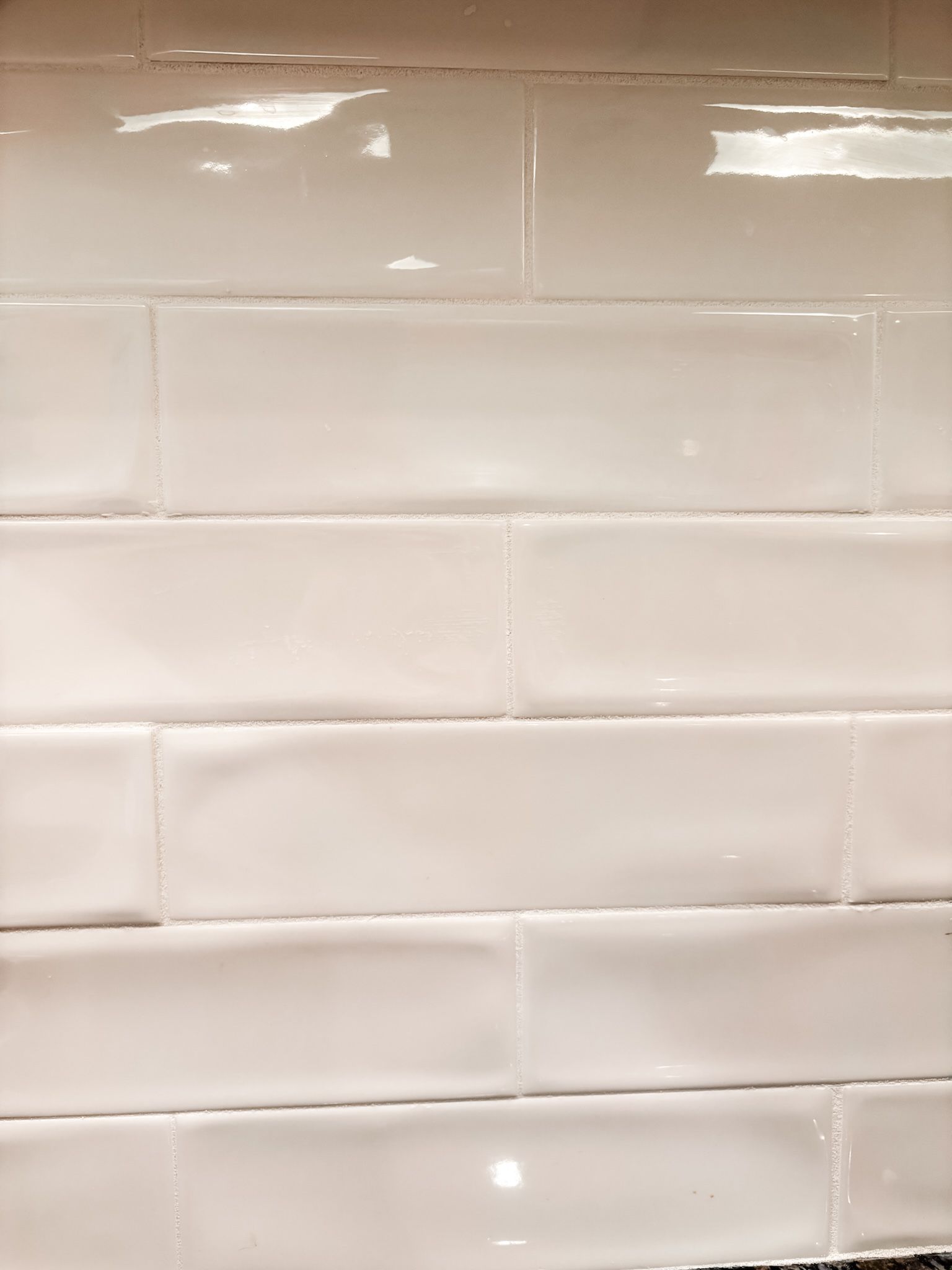White rectangular ceramic tiles on a wall.