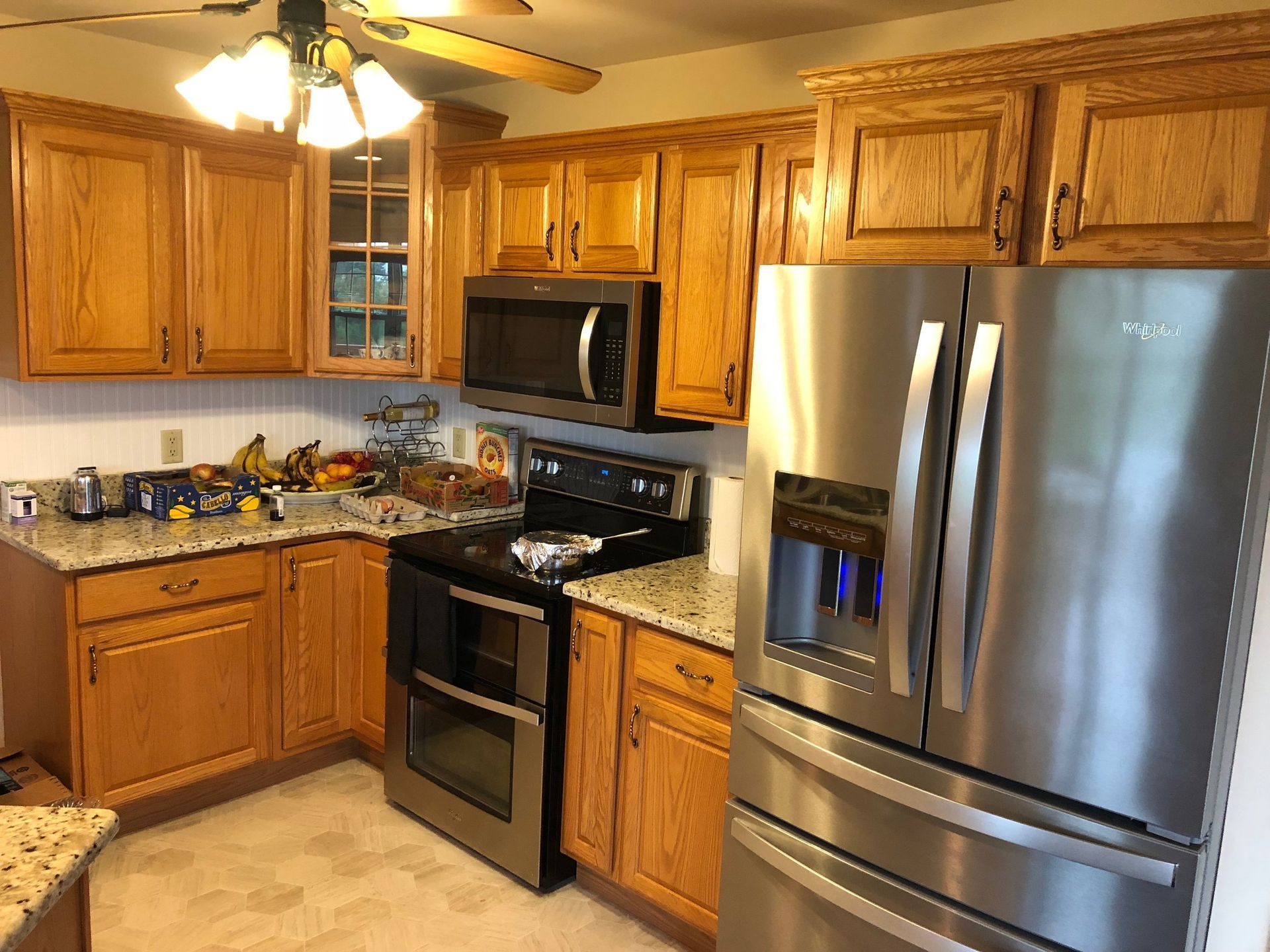 Kitchen with wooden cabinets, stainless steel appliances, and granite countertops.