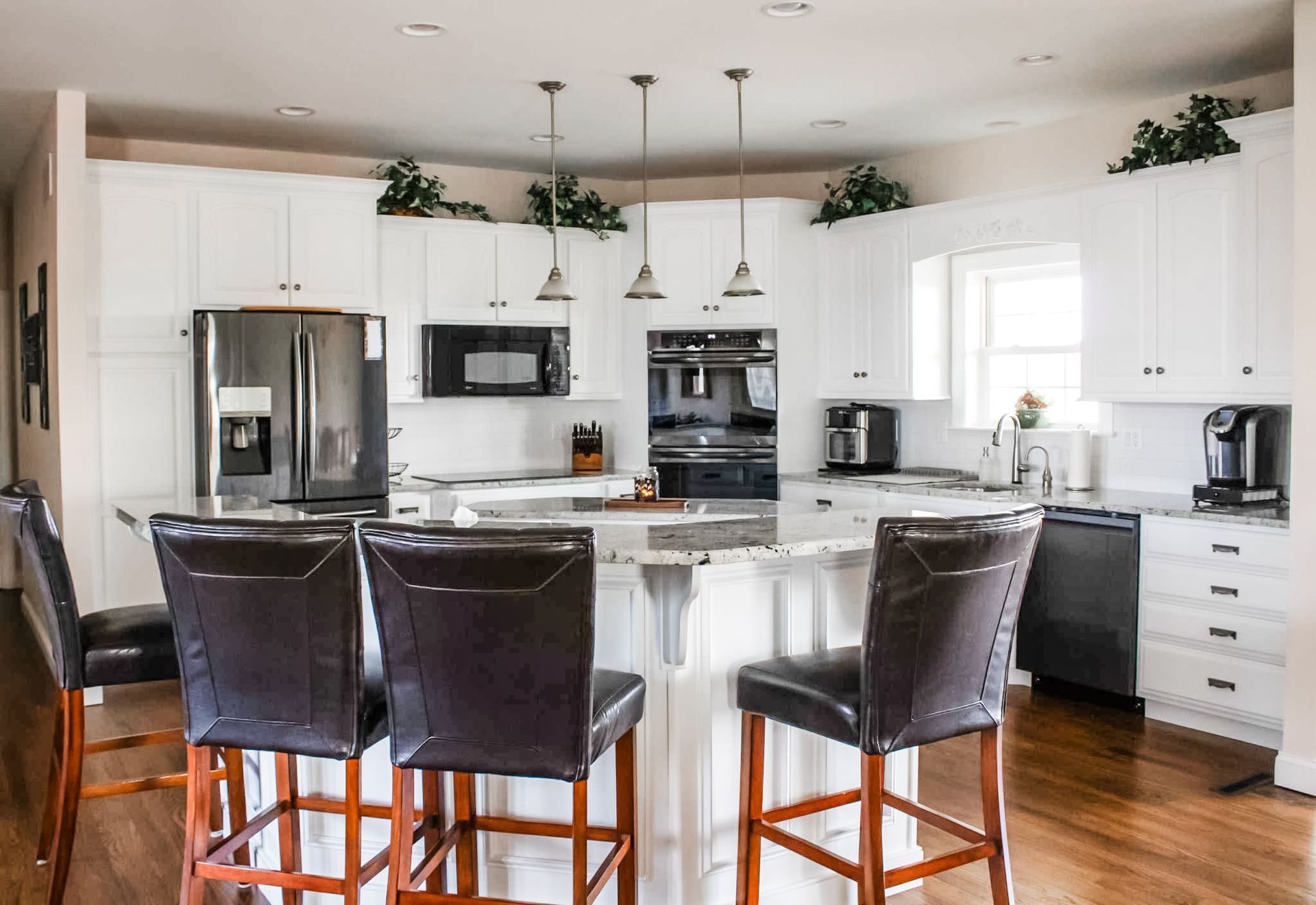 Before: dark wood cabinets; After: light, painted kitchen cabinets | Lapp Cabinet Coatings