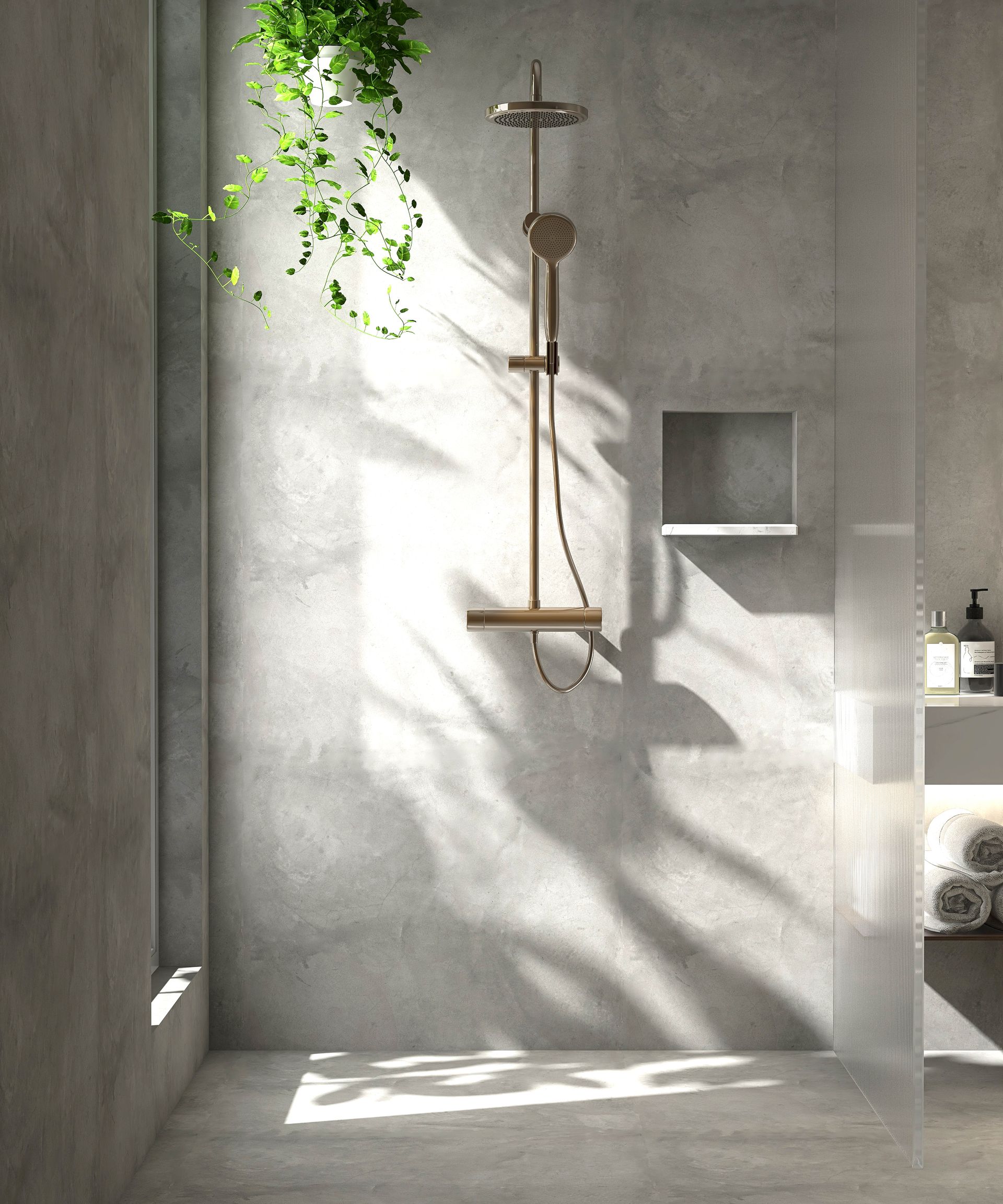 Modern shower with bronze fixtures and hanging plants against a gray concrete wall.