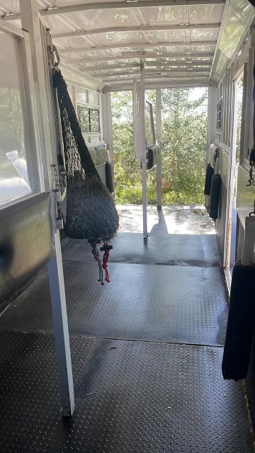 back of equine trailer with hay and back door open