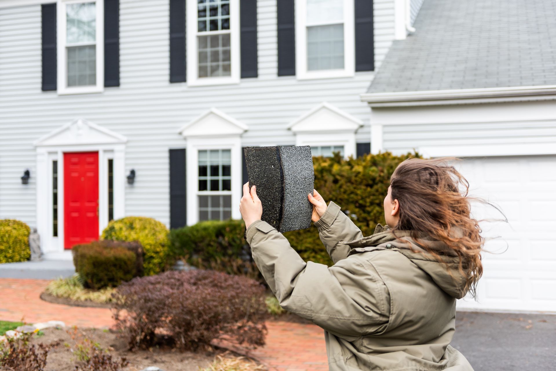 woman in cold weather looking at shingles