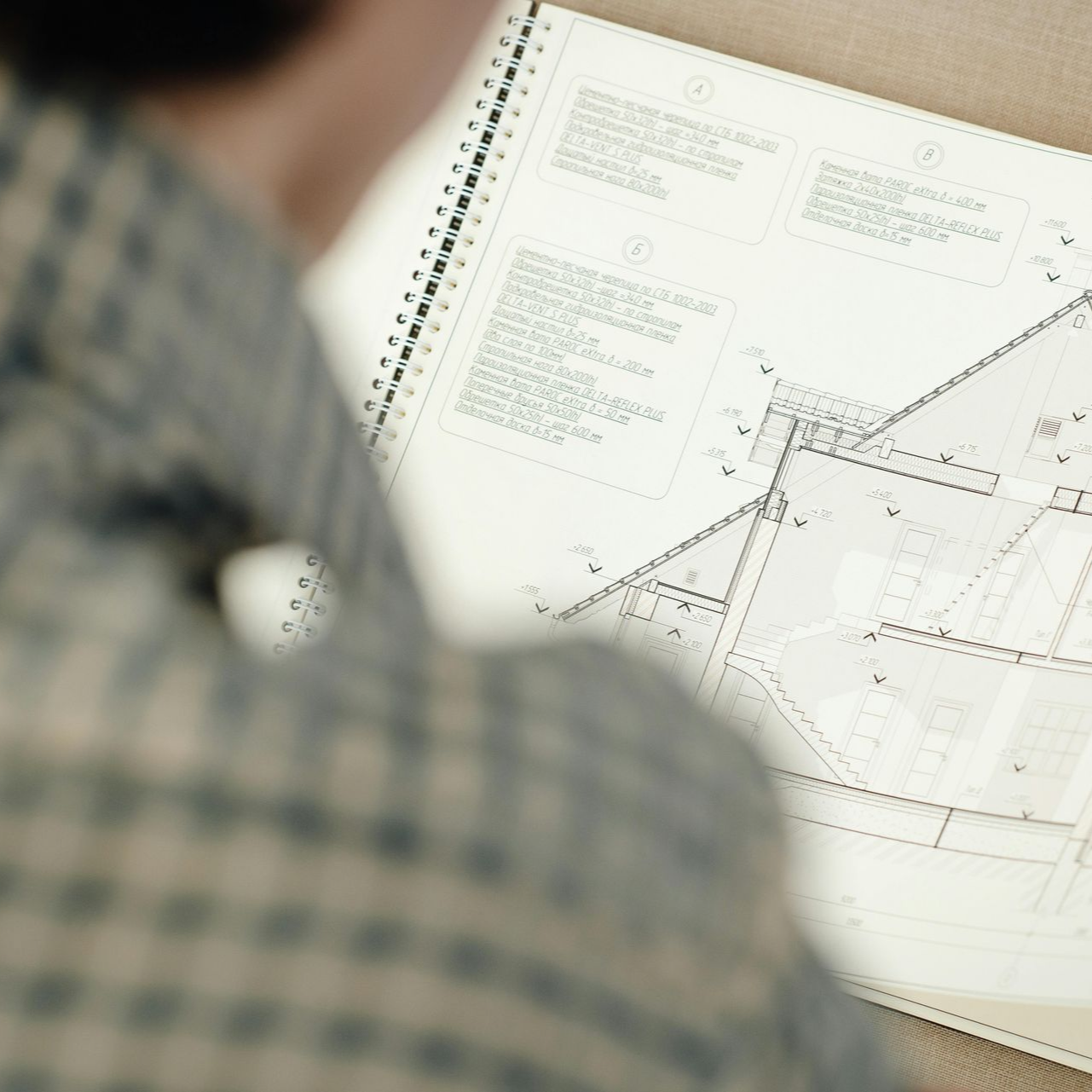 Person looking at architectural blueprints.