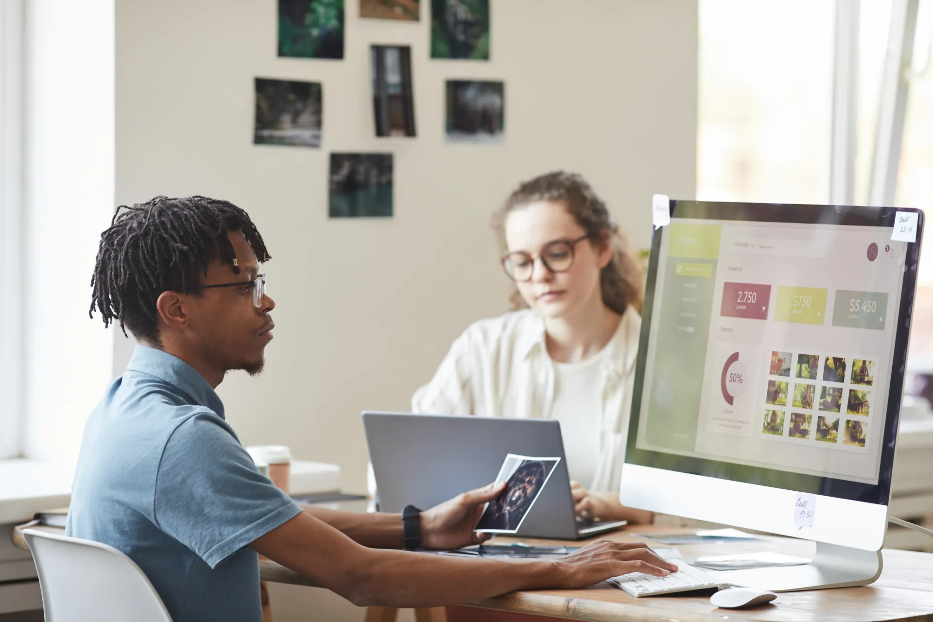 Man and woman reviewing SEO strategy on computer screens in a bright Tucson office, planning a lead generation campaign.