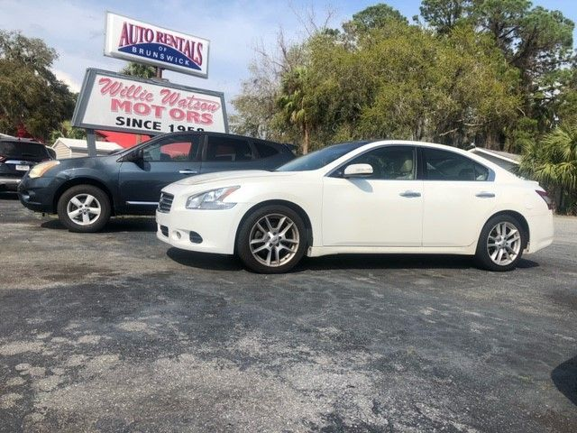 White sedan parked in front of