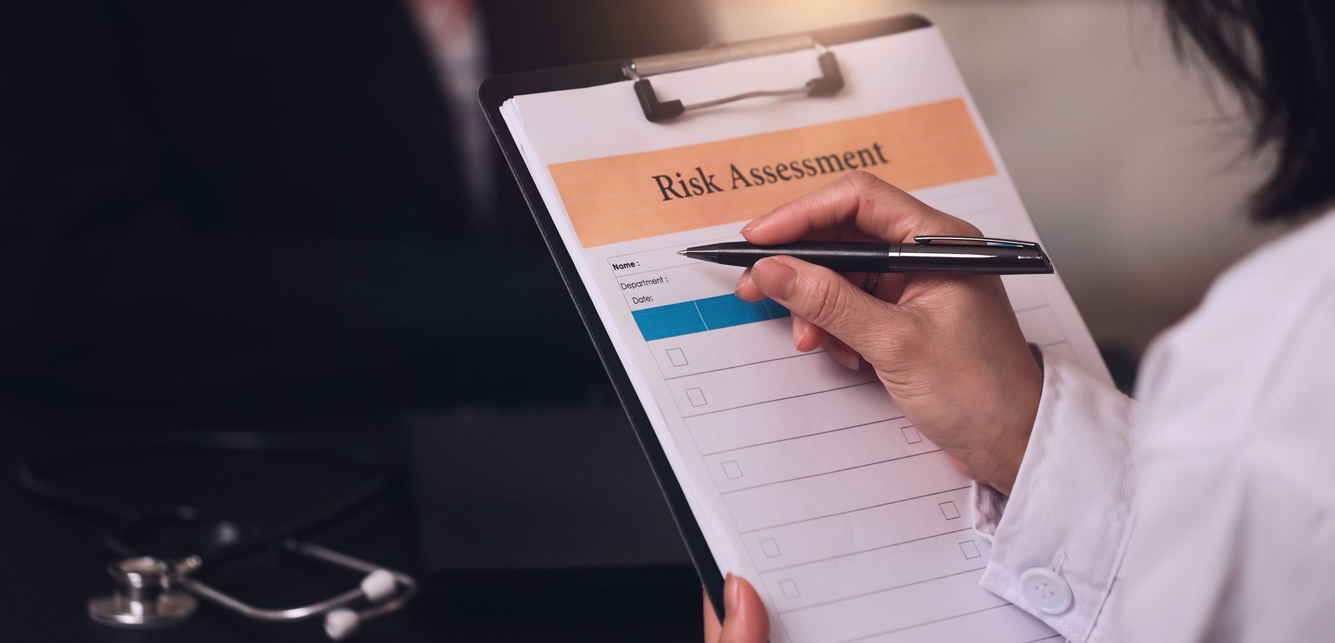 Clipboard appointment checklist with a hand holding a pen over a blue form