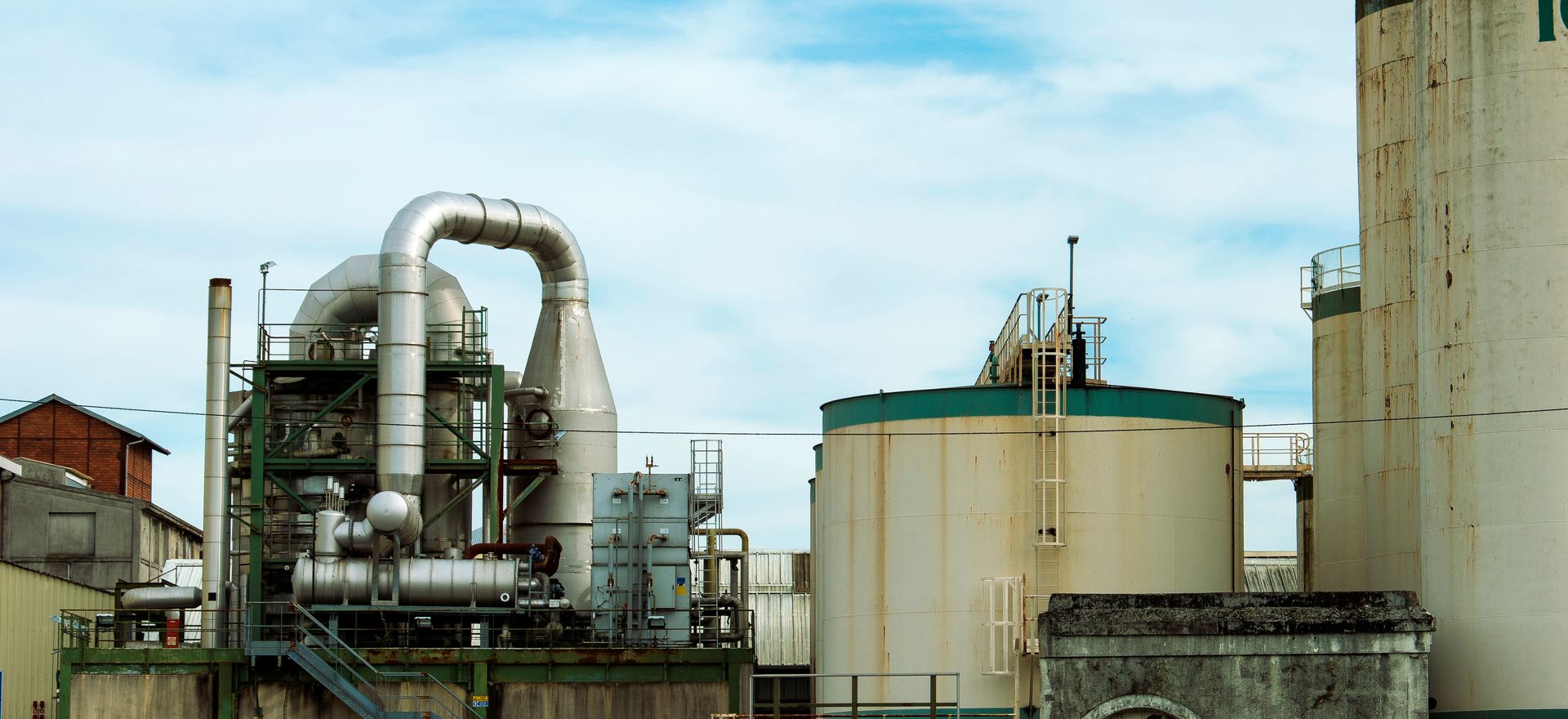 A large factory with a lot of pipes and tanks