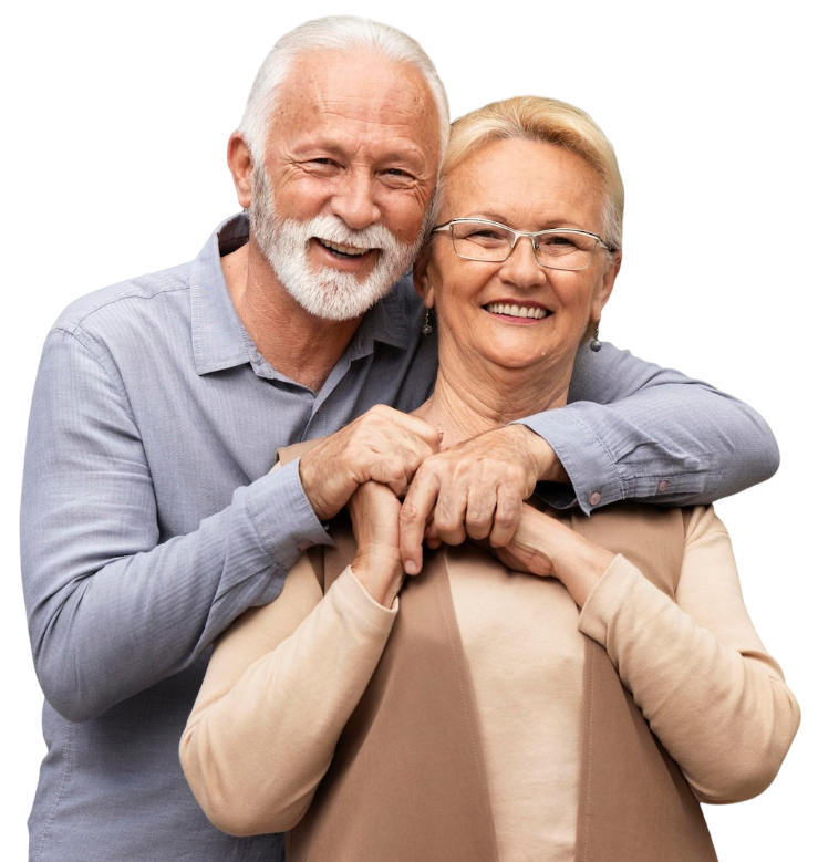Smiling older couple, man with arms around woman, light-colored clothing.