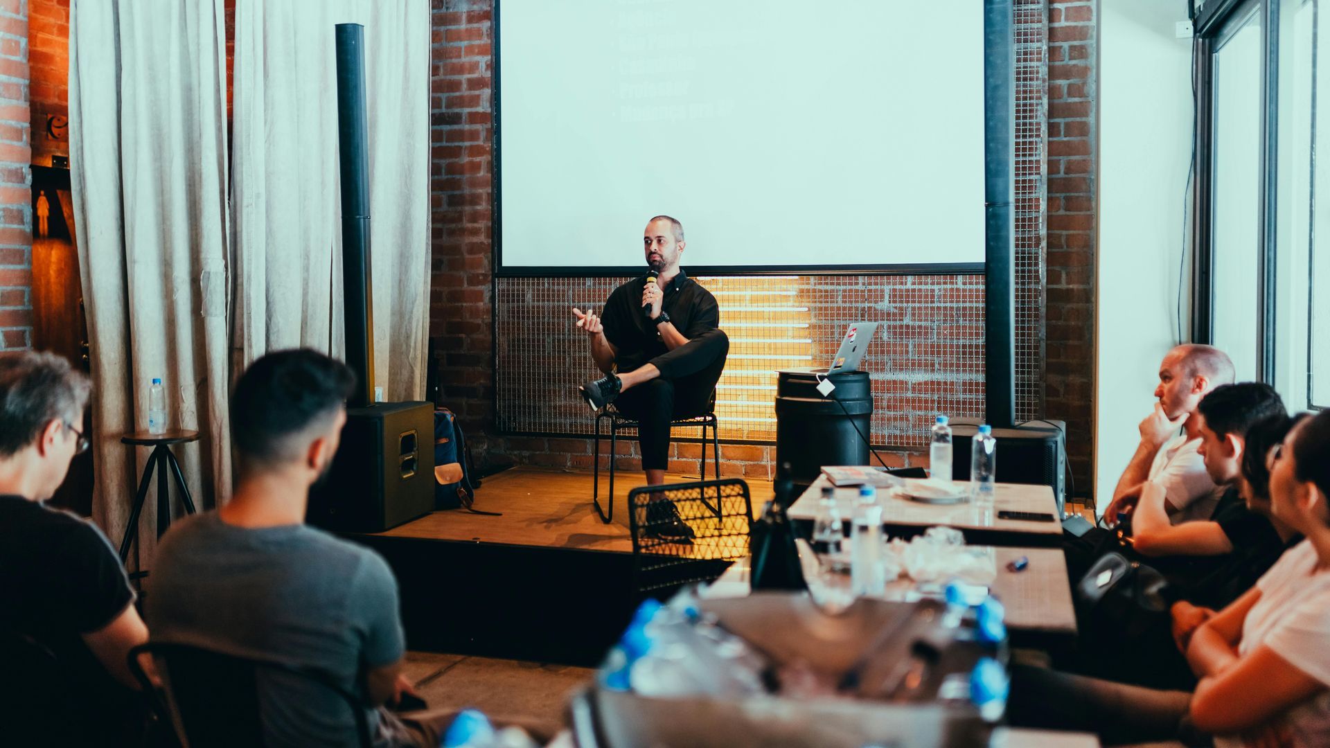 A man is giving a presentation to a group of people in a room.