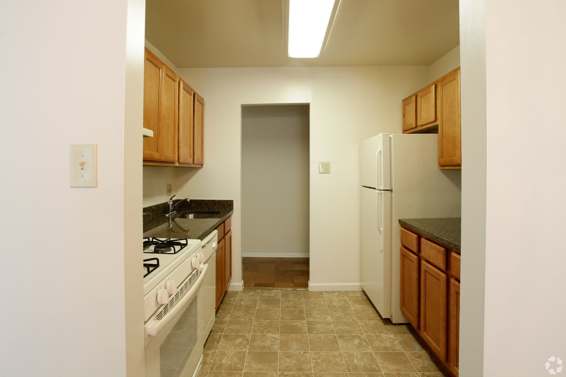 Apartment kitchen with ample cabinet storage and modern finishes