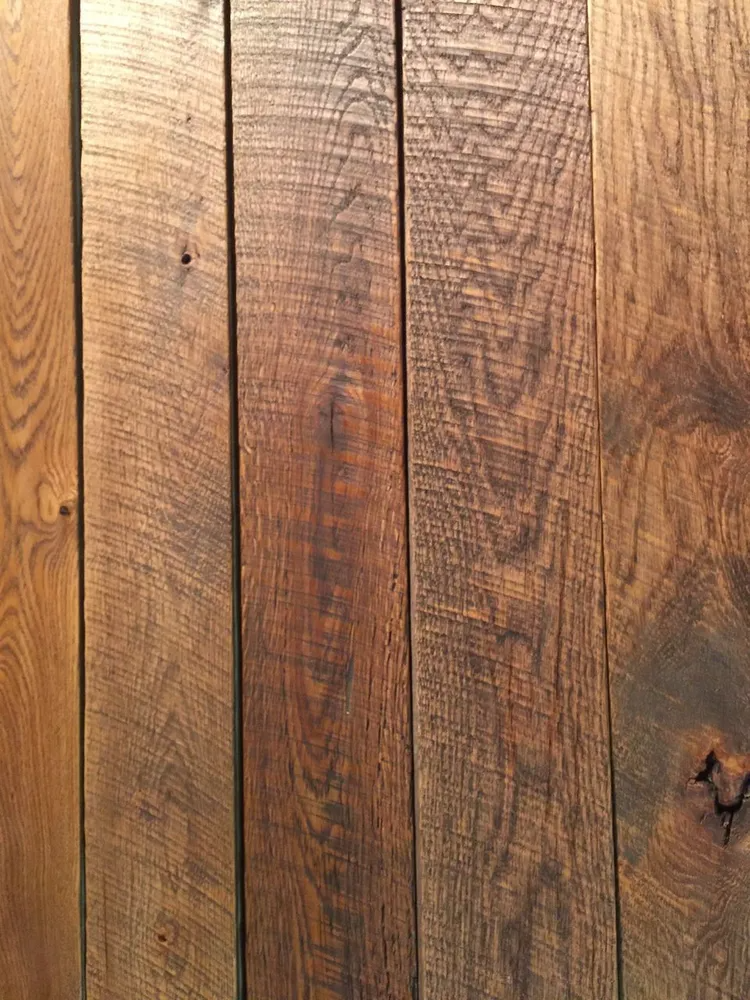 Close-up of weathered brown wooden planks with visible grain and knots