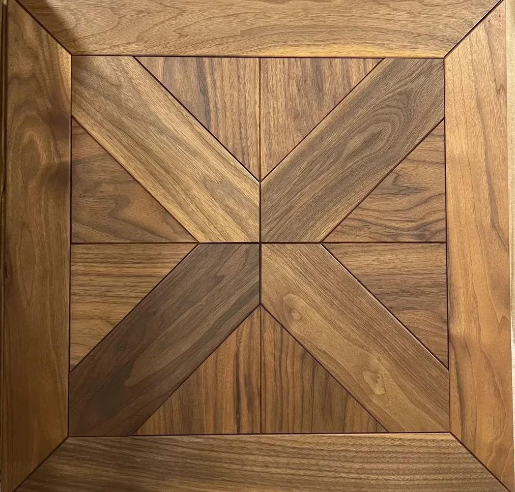 Square wooden panel with a geometric chevron and triangular inlay pattern