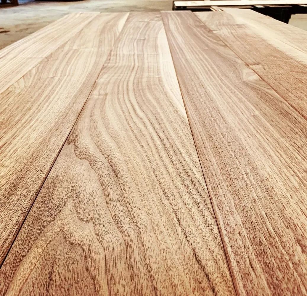Close-up of a light wood tabletop with visible grain and seams