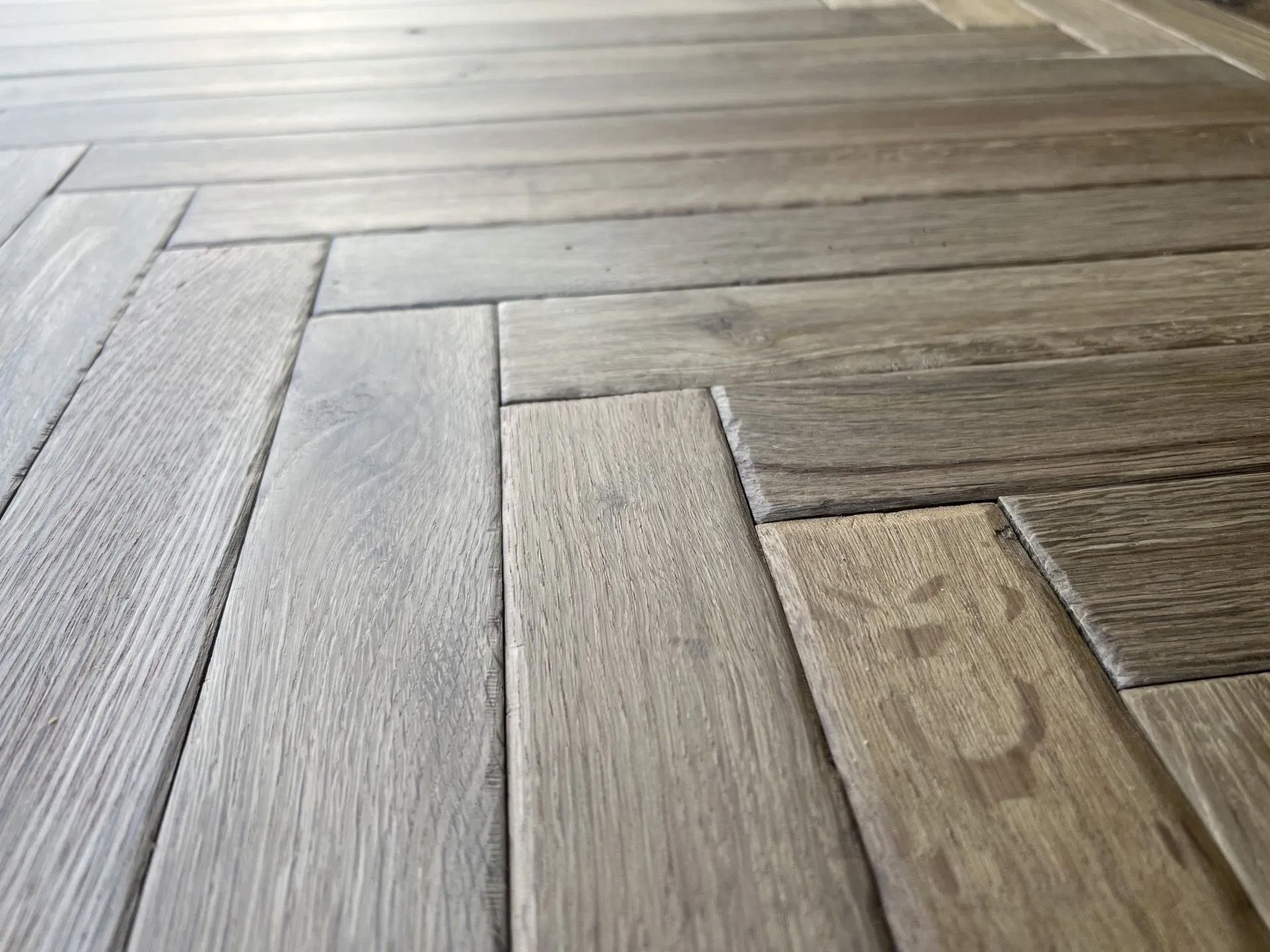 Close-up of light wood plank flooring with varied grain and diagonal perspective