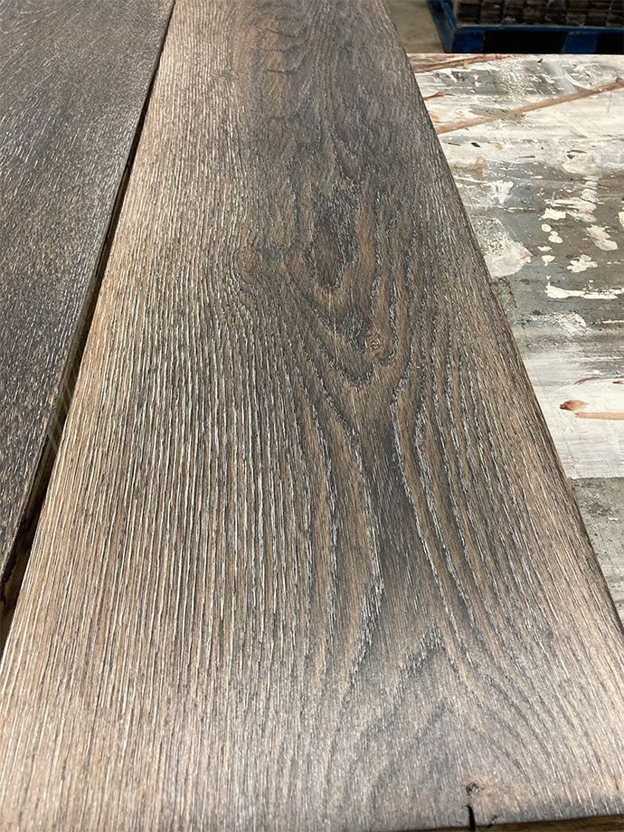 Close-up of weathered gray-brown wooden planks with visible grain and knots