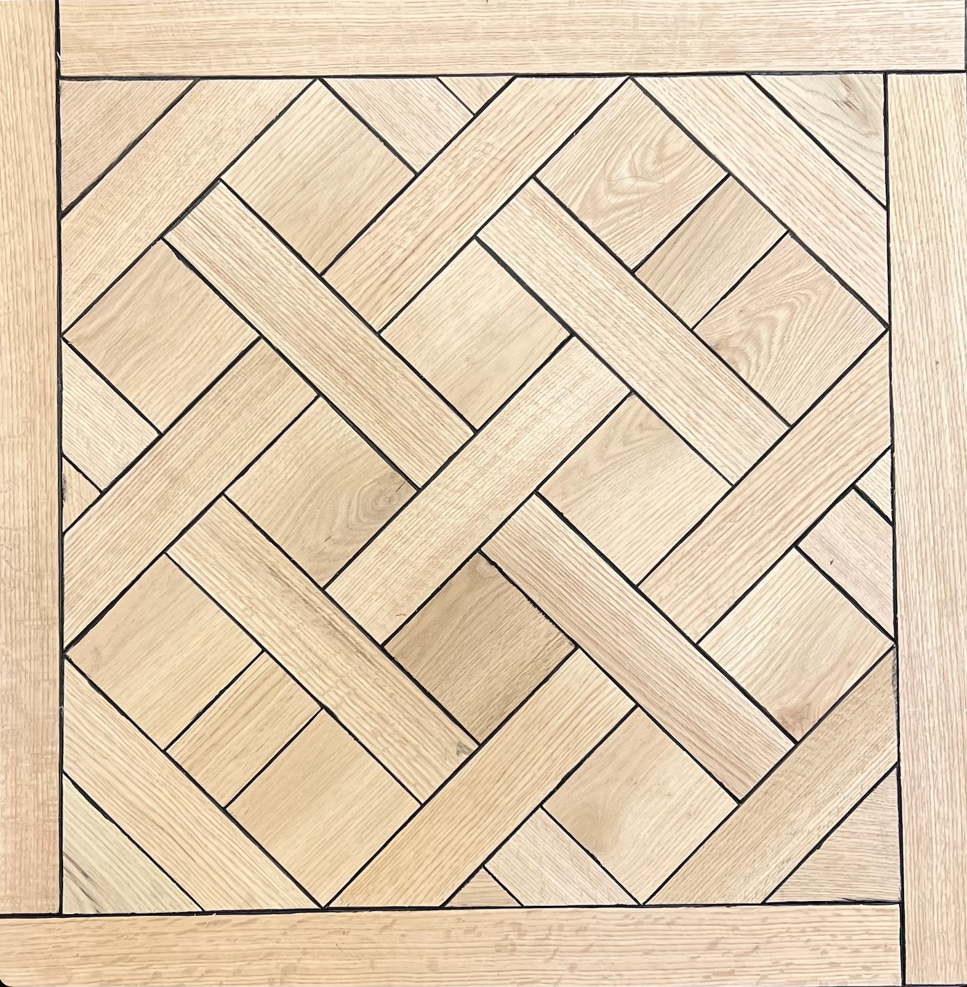 Geometric woven wood parquet pattern in light tan and beige tones