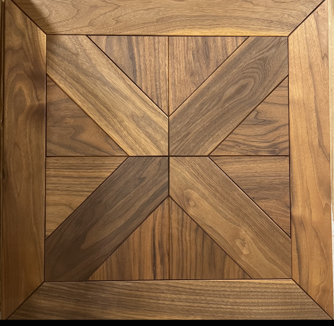Square wooden tray with a geometric herringbone and chevron wood inlay pattern
