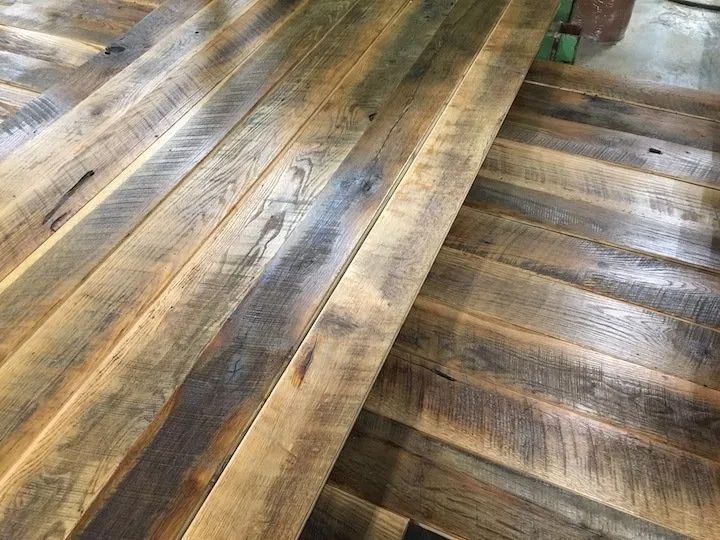 Sunlit weathered wooden deck boards with gray and brown tones