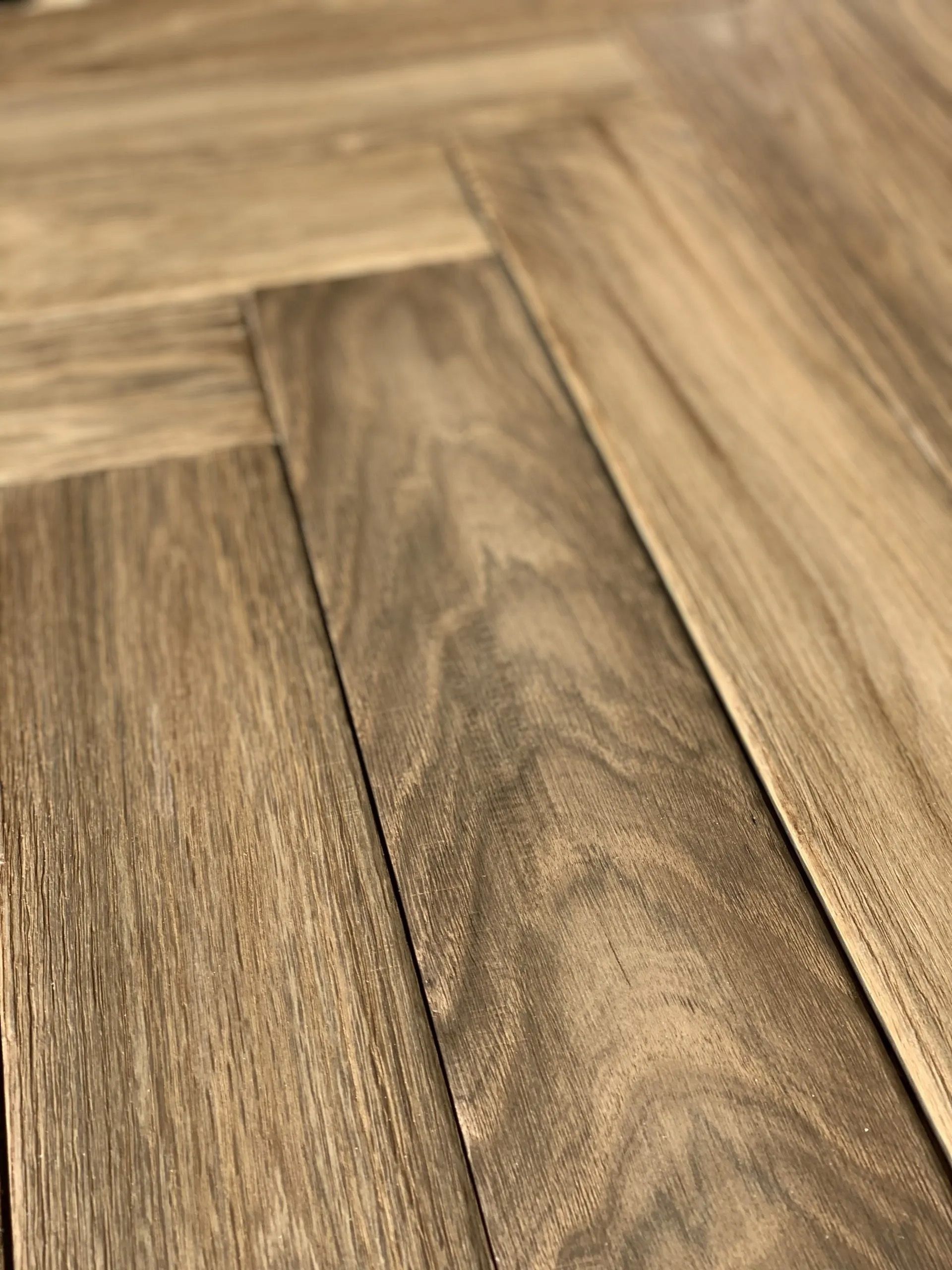 Close-up of brown wooden floorboards with visible grain and planks arranged diagonally