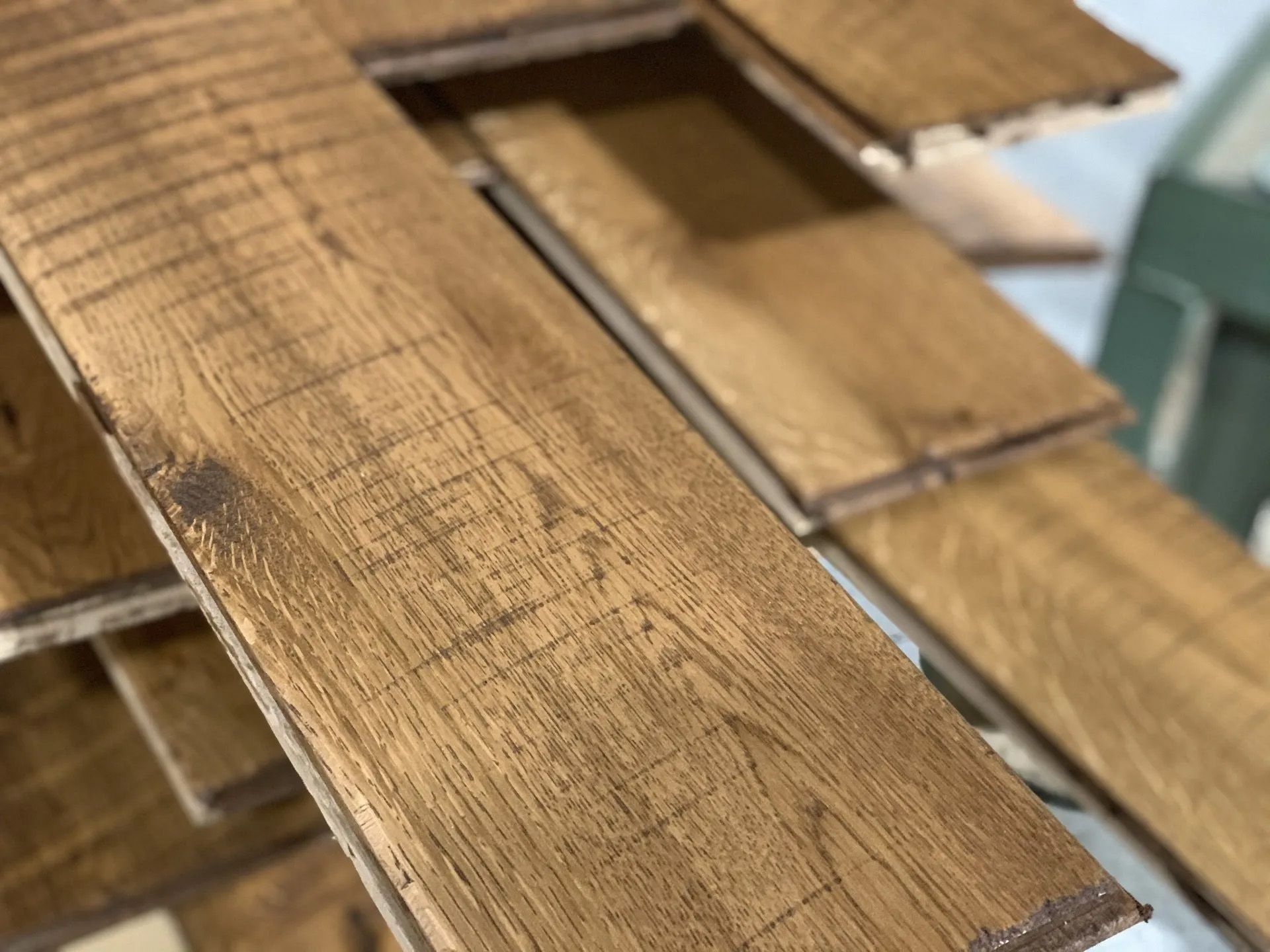Stacked wooden planks with weathered brown grain and a cutout section.