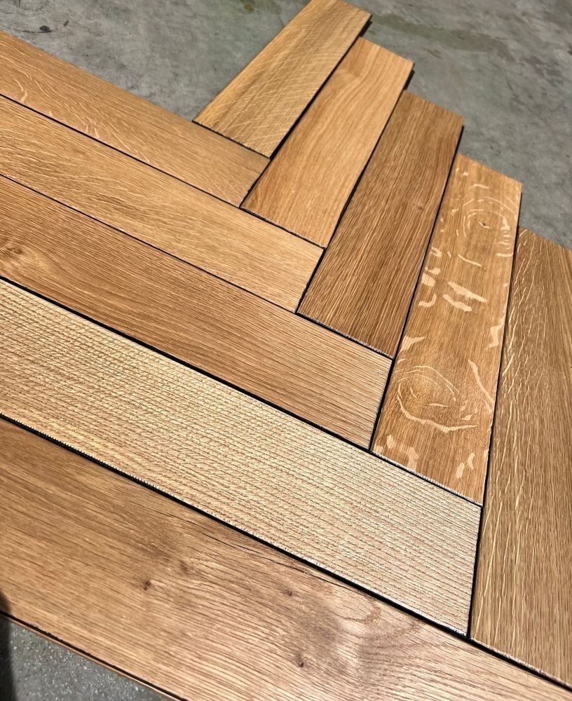 Close-up of woven wood planks in warm brown tones on a concrete floor