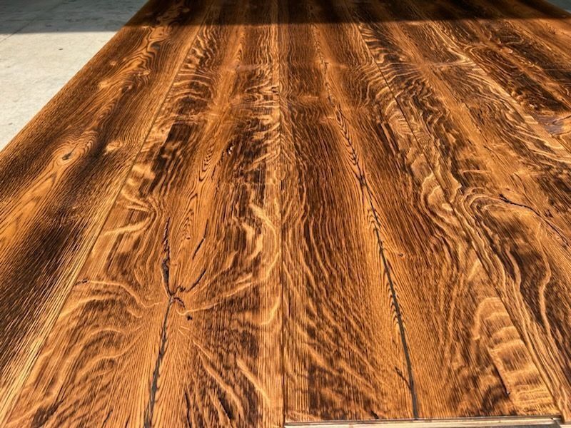 Close-up of a warm brown wooden floor with visible grain and plank seams