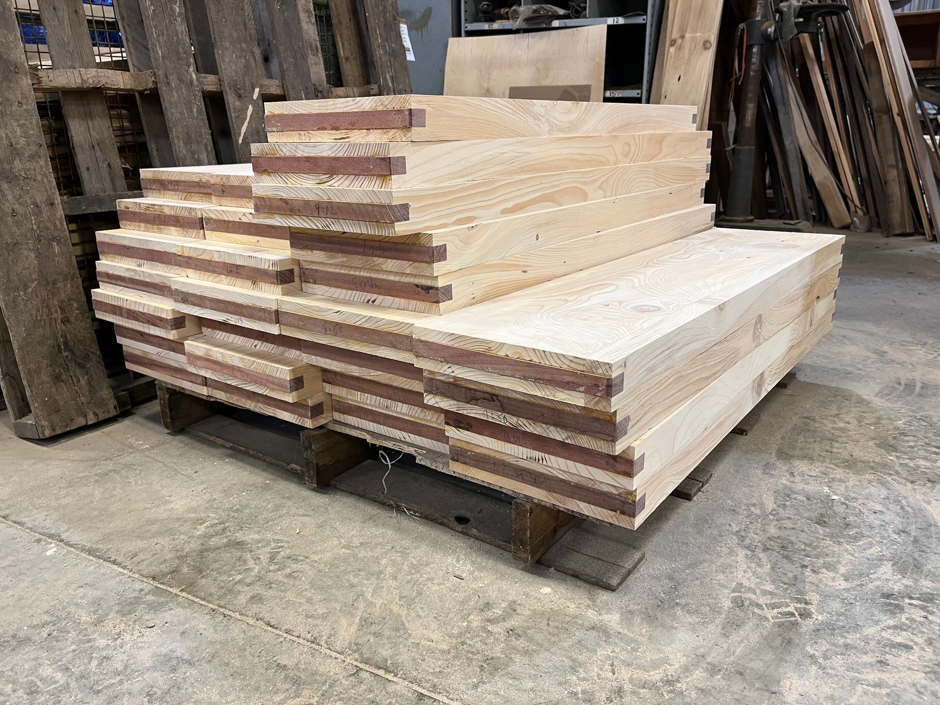 Stacked plywood sheets on pallets in a warehouse or lumber yard