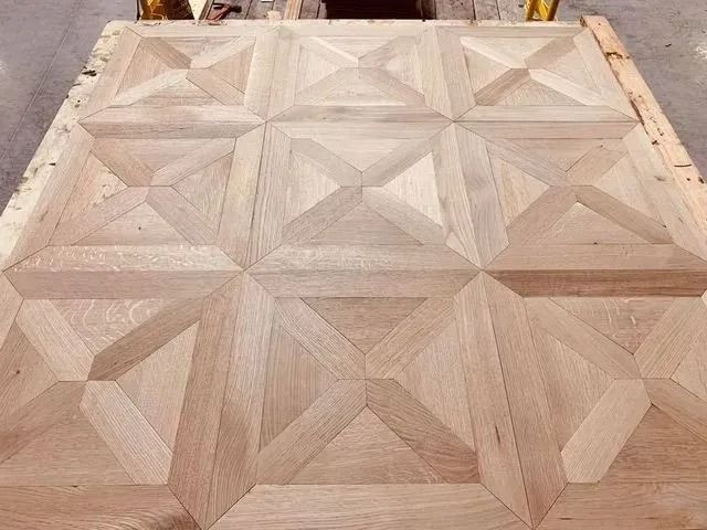 Light wood parquet floor with geometric star and diamond tile pattern