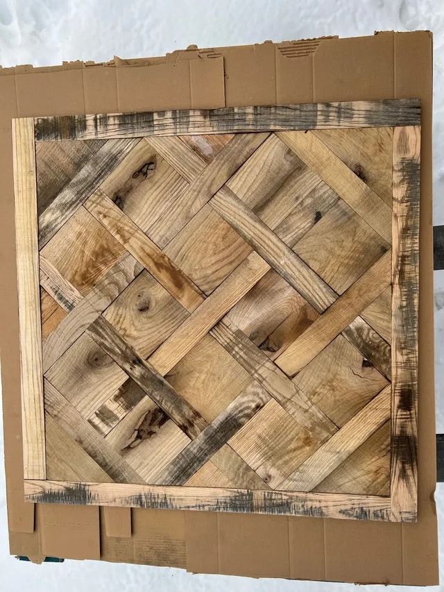 Square woven wood panel with tan and brown crisscross pattern on cardboard backing