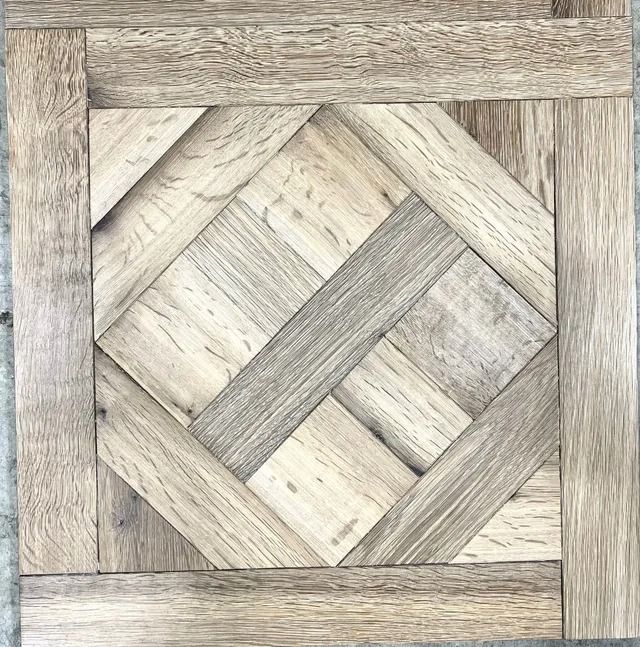 Wooden woven parquet floor pattern with light and dark gray tones