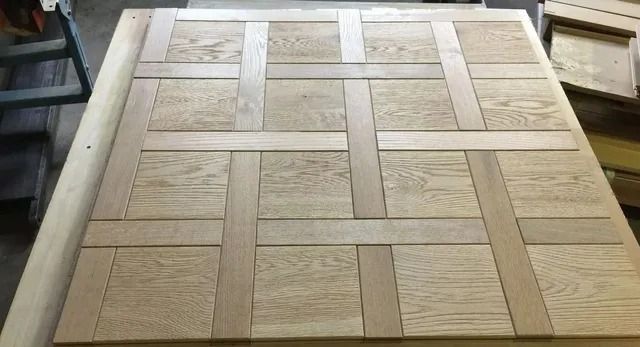 Wooden woven-pattern tabletop or panel with light and dark tan rectangular tiles