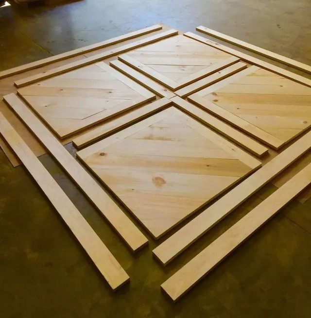 Wooden frame pieces arranged in a square pattern on a floor, with diagonal braces inside each section